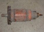 Armature in stock condition with its fan still intact. This armature alone, weighs 170 lbs. That's more than an entire 9 inch motor! Note it's spiraled laminations, good for making smooth and powerful torque.